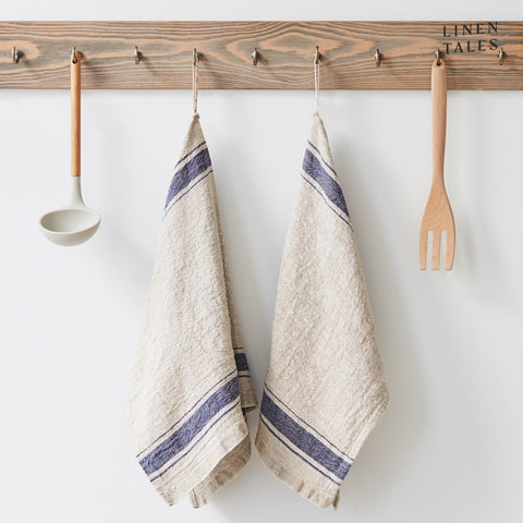 Linen tea towel, 40 x 65 cm, combining the drying and durability qualities of Lithuanian linen with stonewashed softness and appealing print and colour. Shown in Vintage Blue Stripe on Natural. Handmade from 100% linen (310g) in Lithuania by Linen Tales.
