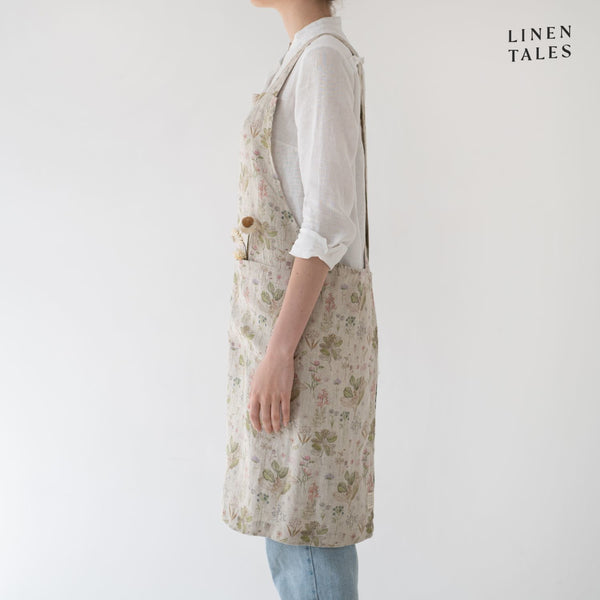 Linen apron, combining the durability quality of Lithuanian linen with stonewashed softness and appealing print and colour. A cross back pinafore design to slip on and off, with no ties. Shown in Botany print on Natural. Handmade from 100% linen (185g) in Lithuania by Linen Tales.