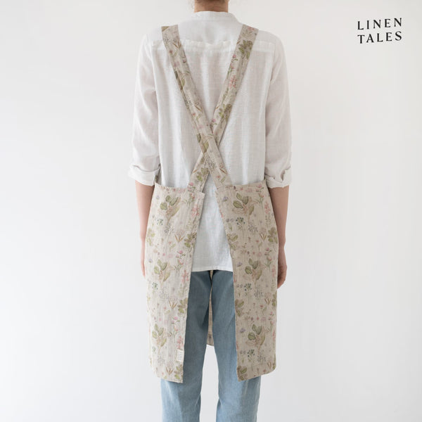 Linen apron, combining the durability quality of Lithuanian linen with stonewashed softness and appealing print and colour. A cross back pinafore design to slip on and off, with no ties. Shown in Botany print on Natural. Handmade from 100% linen (185g) in Lithuania by Linen Tales.