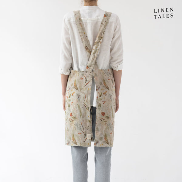 Linen apron, combining the durability quality of Lithuanian linen with stonewashed softness and appealing print and colour. A cross back pinafore design to slip on and off, with no ties. Shown in Leaves print on Natural.