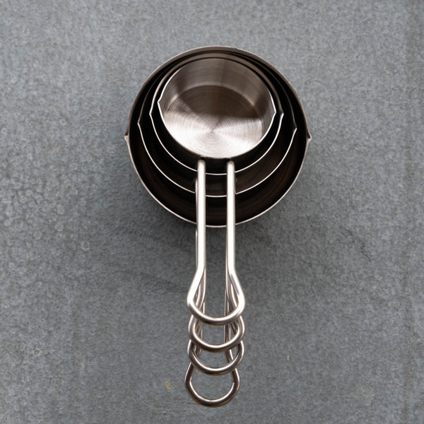 Quality stainless steel measuring cups in four sizes: 1/4 cup 60 ml; 1/3 cup 80 ml; 1/2 cup 125 ml; and 1 cup 250 ml. Small pouring spout on two sides and comfortable handle.