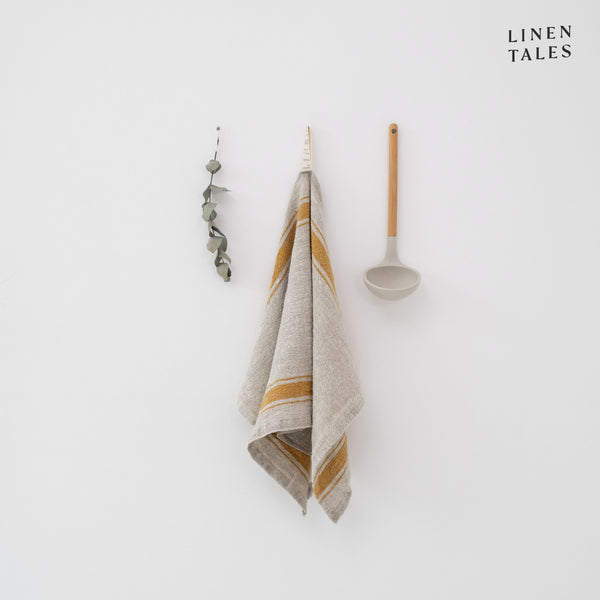 Linen tea towel, 40 x 65 cm, combining the drying and durability qualities of Lithuanian linen with stonewashed softness and appealing print and colour. Shown in Vintage Mustard Stripe on Natural. Handmade from 100% linen (310g) in Lithuania by Linen Tales.