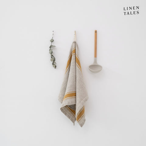 Linen tea towel, 40 x 65 cm, combining the drying and durability qualities of Lithuanian linen with stonewashed softness and appealing print and colour. Shown in Vintage Mustard Stripe on Natural. Handmade from 100% linen (310g) in Lithuania by Linen Tales.