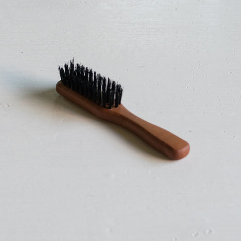 Beards are back and here's a compact timber and synthetic fibre beard brush for keeping that facial hair in check.