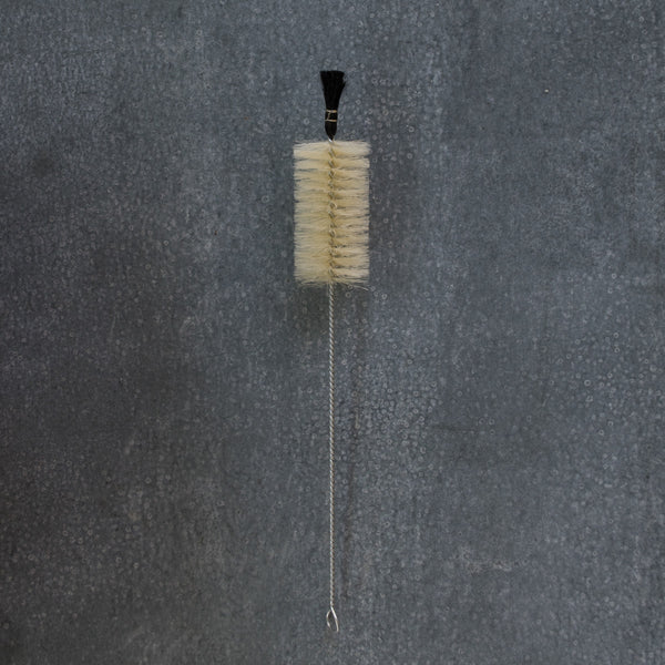 Bottle brush with black tip, designed for vigorous cleaning of hard to reach containers and bottles.