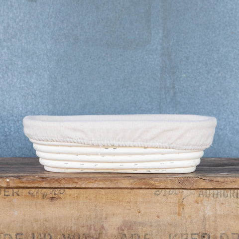 Banneton, oval with cotton lining, for proving homemade bread dough on the second rise to shape an oval loaf. The basket can be used unlined for the pattern of the basket to imprint the dough, or lined for a smooth finish.