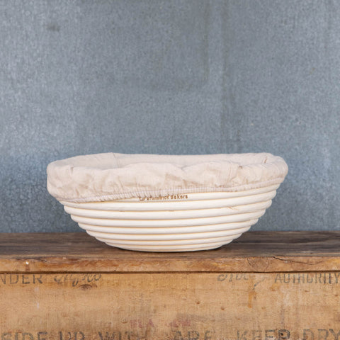 Banneton, round with cotton lining, for proving homemade bread dough on the second rise to shape a round loaf. The basket can be used unlined for the pattern of the basket to imprint the dough, or lined for a smooth finish.