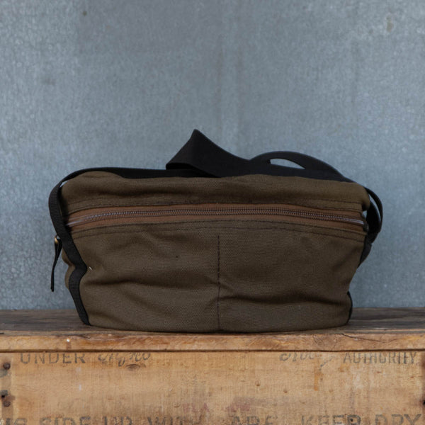 Camp Oven Canvas Bag with padded walls to protect cast iron cookware. Heavy duty cotton canvas bag has reinforced webbing carry straps, built in solid base, and strong reliable zipper.