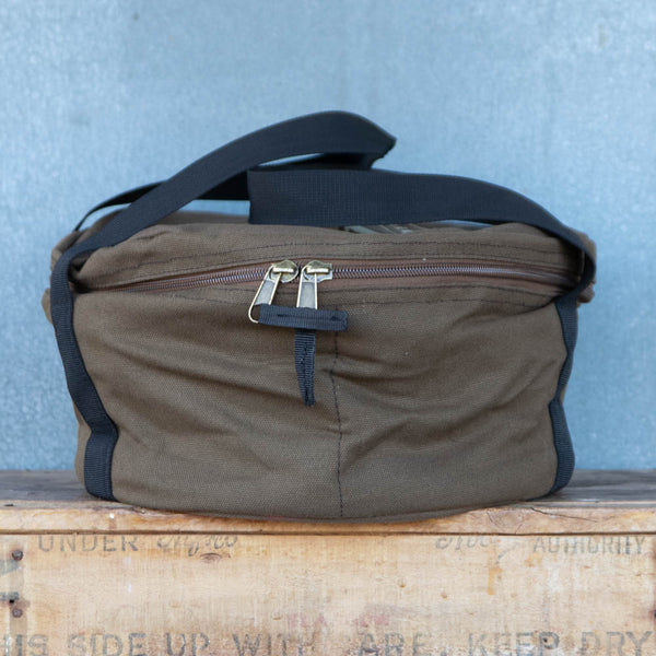 Camp Oven Canvas Bag with padded walls to protect cast iron cookware. Heavy duty cotton canvas bag has reinforced webbing carry straps, built in solid base, and strong reliable zipper.