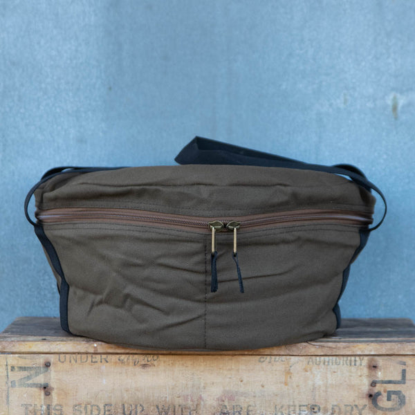 Camp Oven Canvas Bag with padded walls to protect cast iron cookware. Heavy duty cotton canvas bag has reinforced webbing carry straps, built in solid base, and strong reliable zipper.