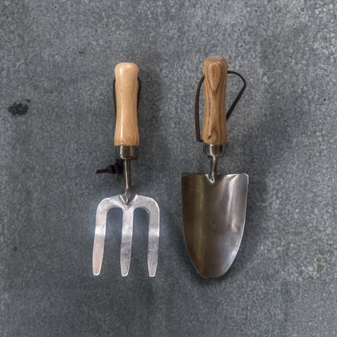 Children's trowel and fork set, made from stainless steel and ash timber with leather hanging straps. Built to last gardening tools with strong handles and made from quality metal, they will take sturdy digging in the garden alongside mum and dad or grandparents.