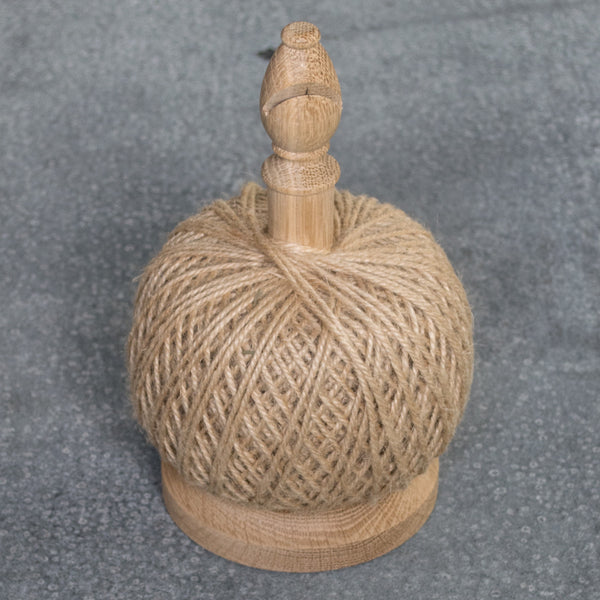 The ultimate string tidy, an oak spool with a cutting blade in the bishop's head, and a 250g ball of jute twine. Store it on your potting bench for easy access to the garden or use it in the house for tying gifts.