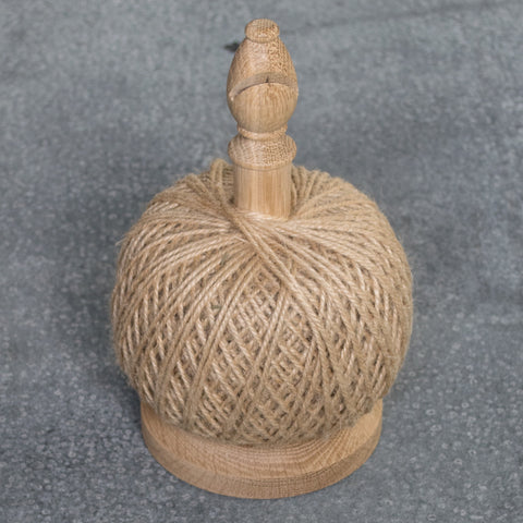 The ultimate string tidy, an oak spool with a cutting blade in the bishop's head, and a 250g ball of jute twine. Store it on your potting bench for easy access to the garden or use it in the house for tying gifts.