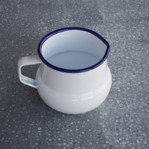 Falcon enamel milk jug, white with blue rim.