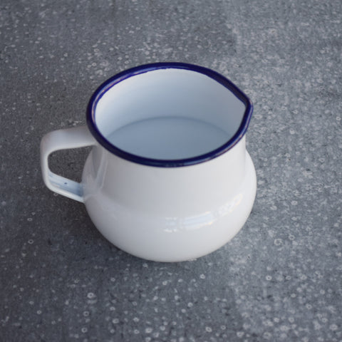 Falcon enamel milk jug, white with blue rim.