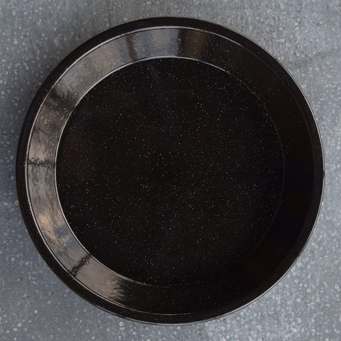 A 30cm diameter, round, Falcon enamel pie plate, black with white speckle, perfect for a large sweet or savoury pie.