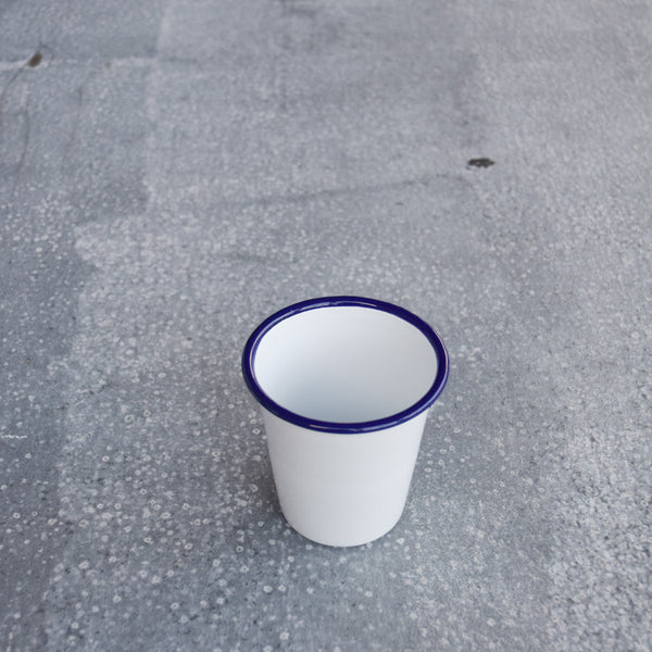 Falcon enamelware tumblers, in white with a blue rim are ideal for ice cold water, hand squeezed orange juice or homemade lemonade. Made by Falcon Enamelware, established 1920, using glass fused onto heavy gauge steel. 