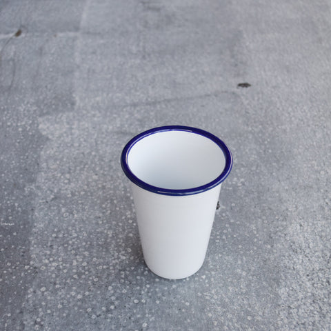 Falcon enamelware tumblers, in white with a blue rim are ideal for ice cold water, hand squeezed orange juice or homemade lemonade. Made by Falcon Enamelware, established 1920, using glass fused onto heavy gauge steel. 