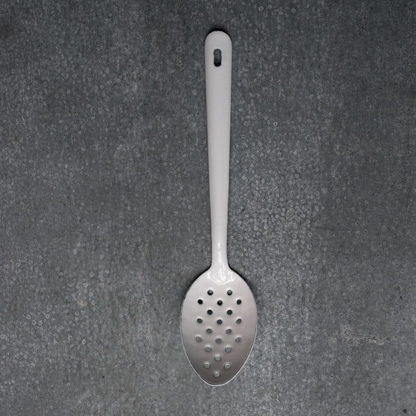 Falcon enamelware perforated spoon in white and 30cm long. Perforated spoons are useful in the kitchen for draining liquids or retrieving foods from liquids.