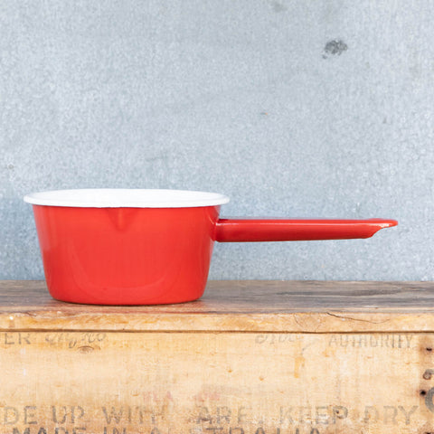 Use our Falcon enamel saucepan in two-tone red exterior and white interior to brew chai, warm milk, or heat a sauce on the stove. The saucepan has two lips for easy pouring, is 850ml, 8cm deep and 14cm diameter.
