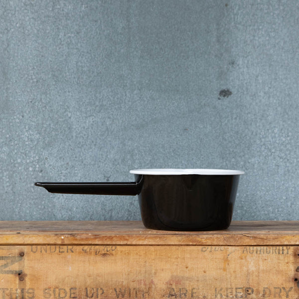 Use our Falcon enamel saucepan in two-tone black exterior and white interior to brew chai, warm milk, or heat a sauce on the stove. The saucepan has two lips for easy pouring, is 850ml, 8cm deep and 14cm diameter. 