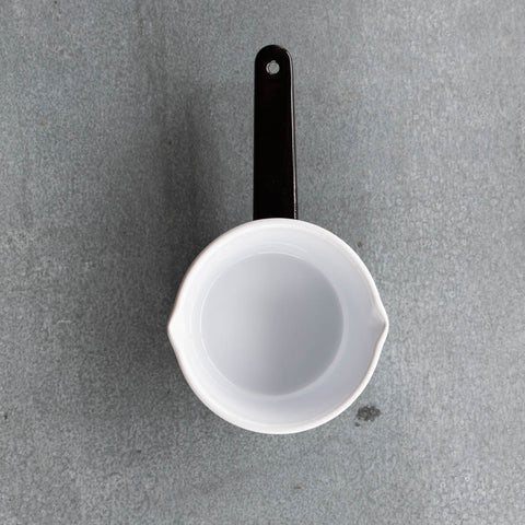 Use our Falcon enamel saucepan in two-tone black exterior and white interior to brew chai, warm milk, or heat a sauce on the stove. The saucepan has two lips for easy pouring, is 850ml, 8cm deep and 14cm diameter. 