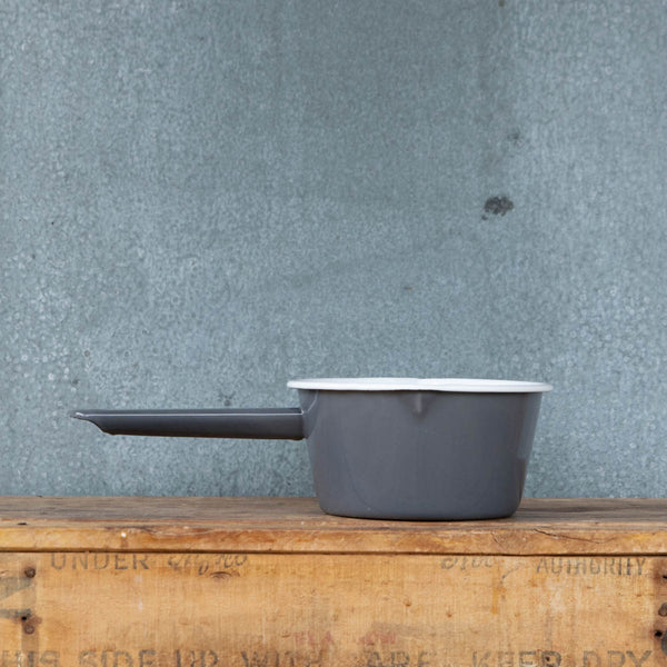 Use our Falcon enamel saucepan in two-tone grey exterior and white interior to brew chai, warm milk, or heat a sauce on the stove. The saucepan has two lips for easy pouring, is 850ml, 8cm deep and 14cm diameter.