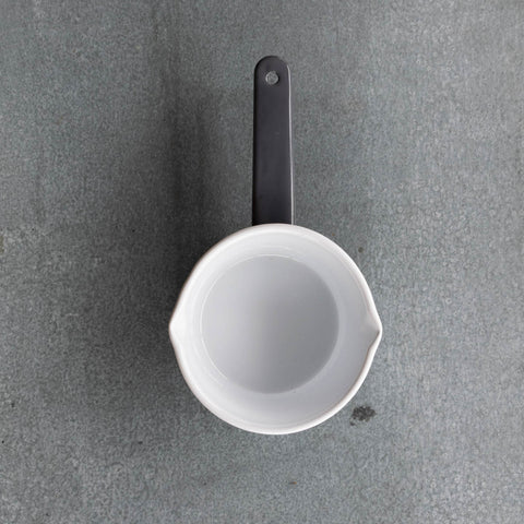 Use our Falcon enamel saucepan in two-tone grey exterior and white interior to brew chai, warm milk, or heat a sauce on the stove. The saucepan has two lips for easy pouring, is 850ml, 8cm deep and 14cm diameter.
