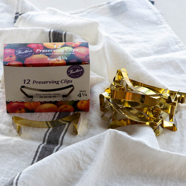 Fowlers Vacola Preserving Clip, Size 4 1/4, in a box of 12. Fits bottle sizes 28,39,42, 56. The Preserving Clip holds the lid in place during the water bath process and allows air to be released from the bottle to create a vacuum seal. 