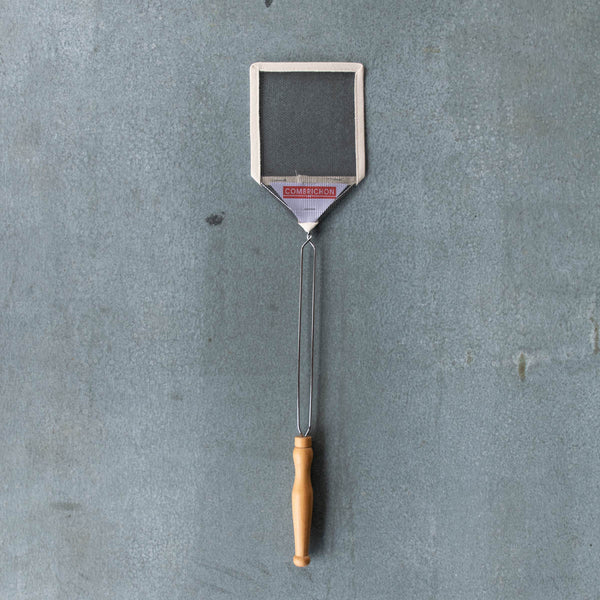 Wire mesh fly swat with cotton webbing surround. Steel and turned timber handle for generous reach and strength. 