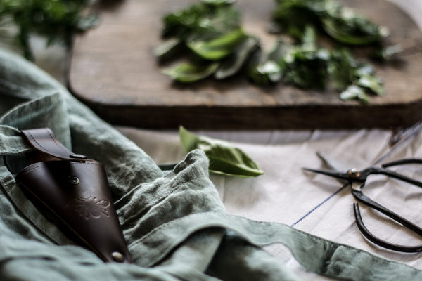 Keep metal herb or flower scissors handy, stored in a recycled leather pouch threaded onto your belt or apron tie. Perfect for snipping herbs for the night's dinner, or light stems of flowers. 