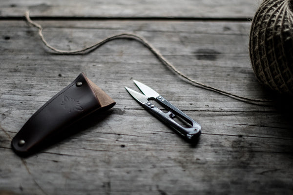 Keep metal gardening snips or small shears handy, stored in a recycled leather pouch threaded onto your belt or apron tie. Perfect for snipping herbs and vegetables for the night's dinner, light deadheading spent flowers or pruning.