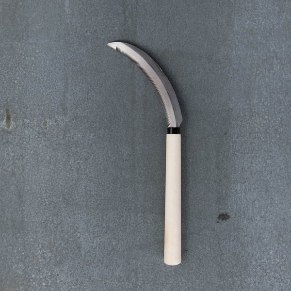 Hand Sickle, with a curved, serrated 18cm carbon steel blade and 20cm timber handle. A multi-purpose tool for harvesting vegetables and cutting grass.