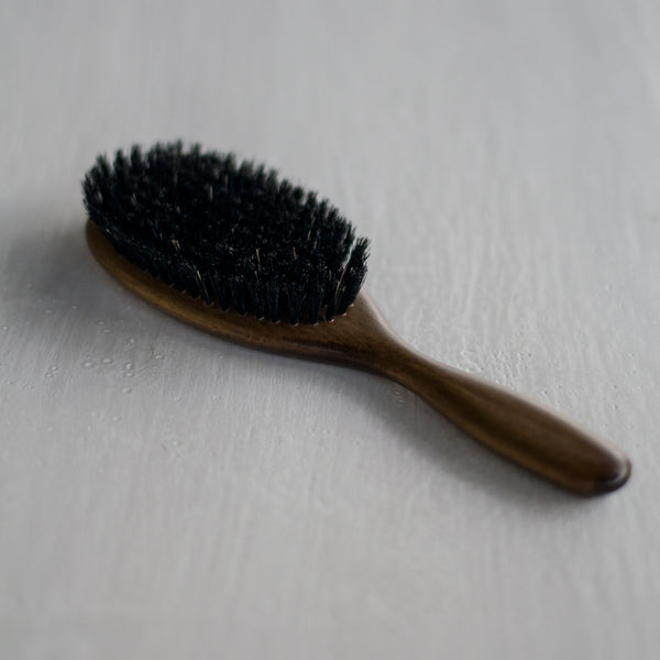 Enjoy the classic oval shape of this hair brush with quality, dark, wild boar bristles, and lovely to hold, beechwood handle with nutwood varnish. The bristles have extra graduation for a firm grip on your hair.