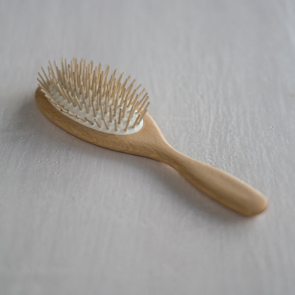 A classic shaped, handcrafted hairbrush made of waxed beechwood handle, and cushion with round, maplewood pins. The maplewood pins gently massage the scalp. while protecting hair follicles.
