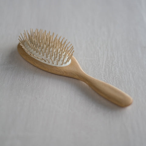 A classic shaped, handcrafted hairbrush made of waxed beechwood handle, and cushion with round, maplewood pins. The maplewood pins gently massage the scalp. while protecting hair follicles.