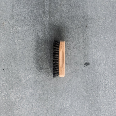 A compact shoe shining brush made from timber and dark horse hair. Sits comfortably in the palm of your hand. Handle dimensions 12cm x 4cm. Bristle length 2cm.