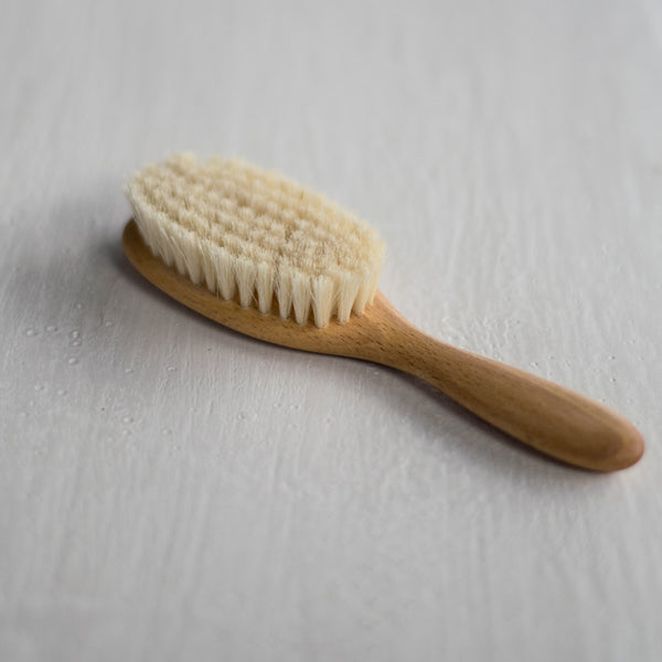Children's hairbrush with soft natural bristles and beechwood handle, ideal for sensitive scalps and hair from one year and up. Its small size and beautifully shaped handle make this wooden hairbrush easy to hold and use.