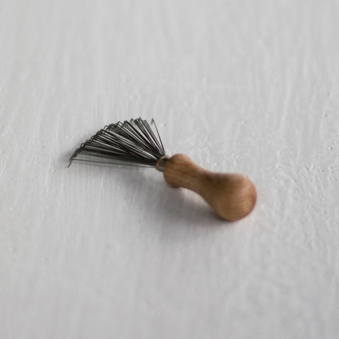 Comb and hairbrush cleaner, made from wire and timber, to remove hair from your hair combs and brushes.