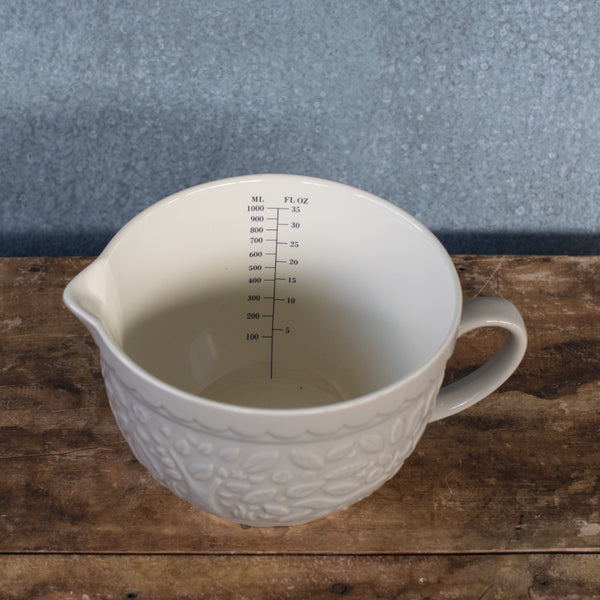 Part of the Mason Cash In the Forest range, the stone-coloured measuring jug is  embossed with mid-19th Century folk-inspired forest scene, featuring foxes. Versatile for measuring, mixing, storing, and serving needs in the kitchen. Made from heavy chip resistant stoneware, with internal metric and imperial measuring marks. 