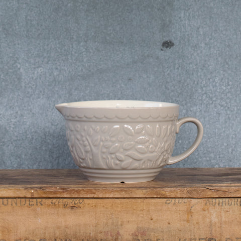Part of the Mason Cash In the Forest range, the stone-coloured measuring jug is  embossed with mid-19th Century folk-inspired forest scene, featuring foxes. Versatile for measuring, mixing, storing, and serving needs in the kitchen. Made from heavy chip resistant stoneware, with internal metric and imperial measuring marks. 