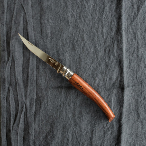 An Opinel fish filleting pocket knife with slimline polished stainless steel blade and Padauk handle. Available in four sizes 8cm, 10cm, 12cm, and 15cm. Made in France since 1890, Opinel knives are reliable, robust and easy to use.