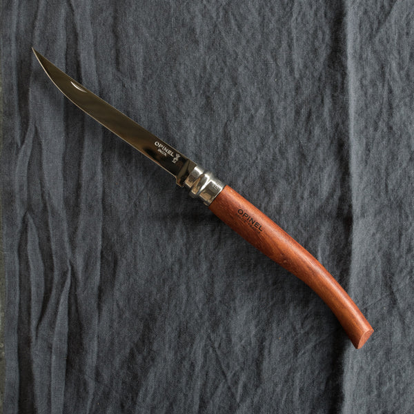 An Opinel fish filleting pocket knife with slimline polished stainless steel blade and Padauk handle. Available in four sizes 8cm, 10cm, 12cm, and 15cm. Made in France since 1890, Opinel knives are reliable, robust and easy to use.
