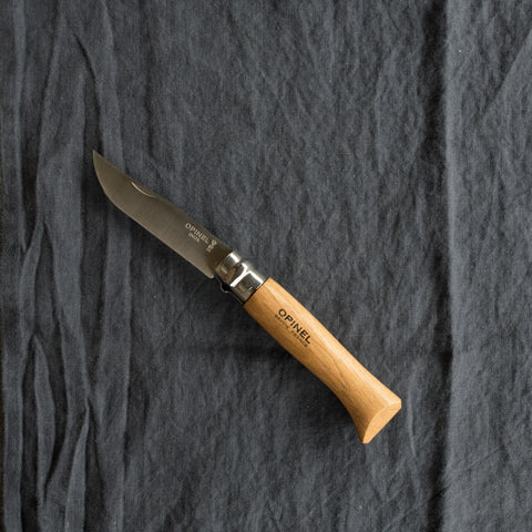 An Opinel No. 8 pocket knife with a stainless steel blade and specialty timber handle, in oak, olive, bubinga or walnut. Current stock may not be stamped 'Opinel'.Made in France since 1890, Opinel knives are reliable, robust and easy to use. They have a trademark safety ring, which locks the blade in the open or closed position.