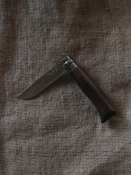 An Opinel No. 8 pocket knife with a stainless steel blade and specialty timber handle, in oak, olive, bubinga or walnut. Current stock may not be stamped 'Opinel'.Made in France since 1890, Opinel knives are reliable, robust and easy to use. They have a trademark safety ring, which locks the blade in the open or closed position.