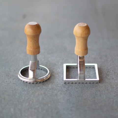 Use our set of two ravioli cutters to create homemade ravioli. Make and roll out a pasta dough using a pasta roller or rolling pin and cut round or square ravioli shapes before adding filling, cooking and serving with sauce.